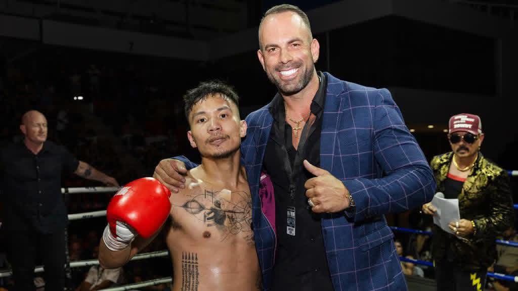 Fighter and promoter ringside after the win