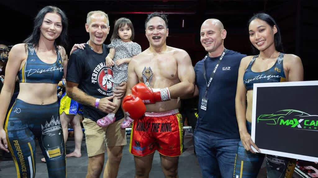 Winning fighter with his trophy after the bout
